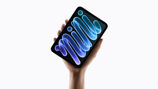 A hand holding a tablet displaying a stylized blue 'mini' graphic on the screen.